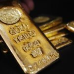 Gold holds near record high, Fed rate cut bets support