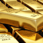 Gold prices fall but record highs remain in sight