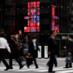 Japan keeps economic recovery view, flags US policy risks